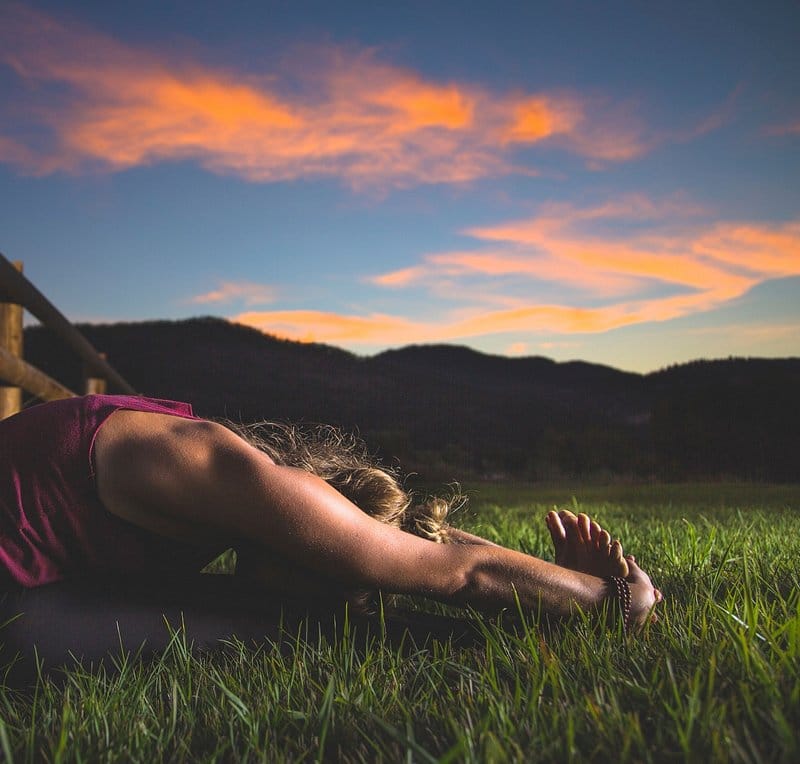 Yoga practice on the grass at golden hour